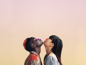 Two women with their chins together looking up with bright pink and orange Noz reef safe sunscreen on their noses.