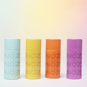 Orange, purple, yellow and blue sticks of Nöz sunscreen, the best reef safe, zinc oxide SPF for your face, lined up