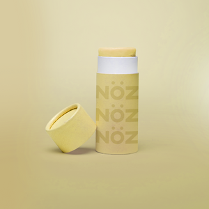 A single yellow stick of Nöz sunscreen, the best reef safe, zinc oxide SPF for your face, with its cap off